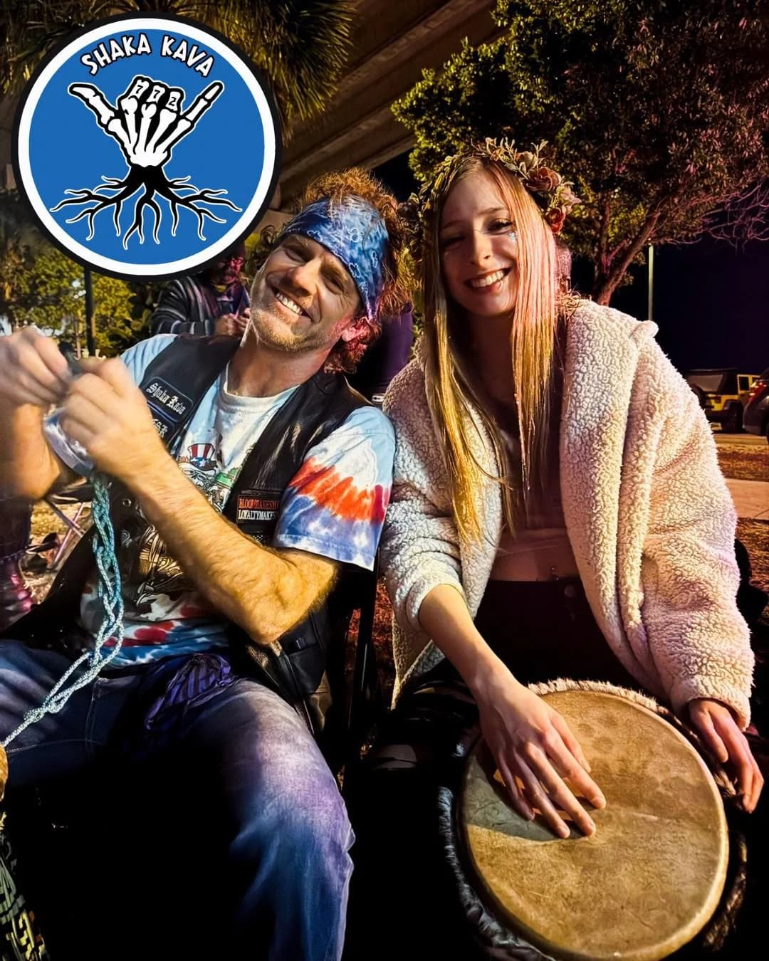 Two regulars laughing with a hand drum at drum circle night